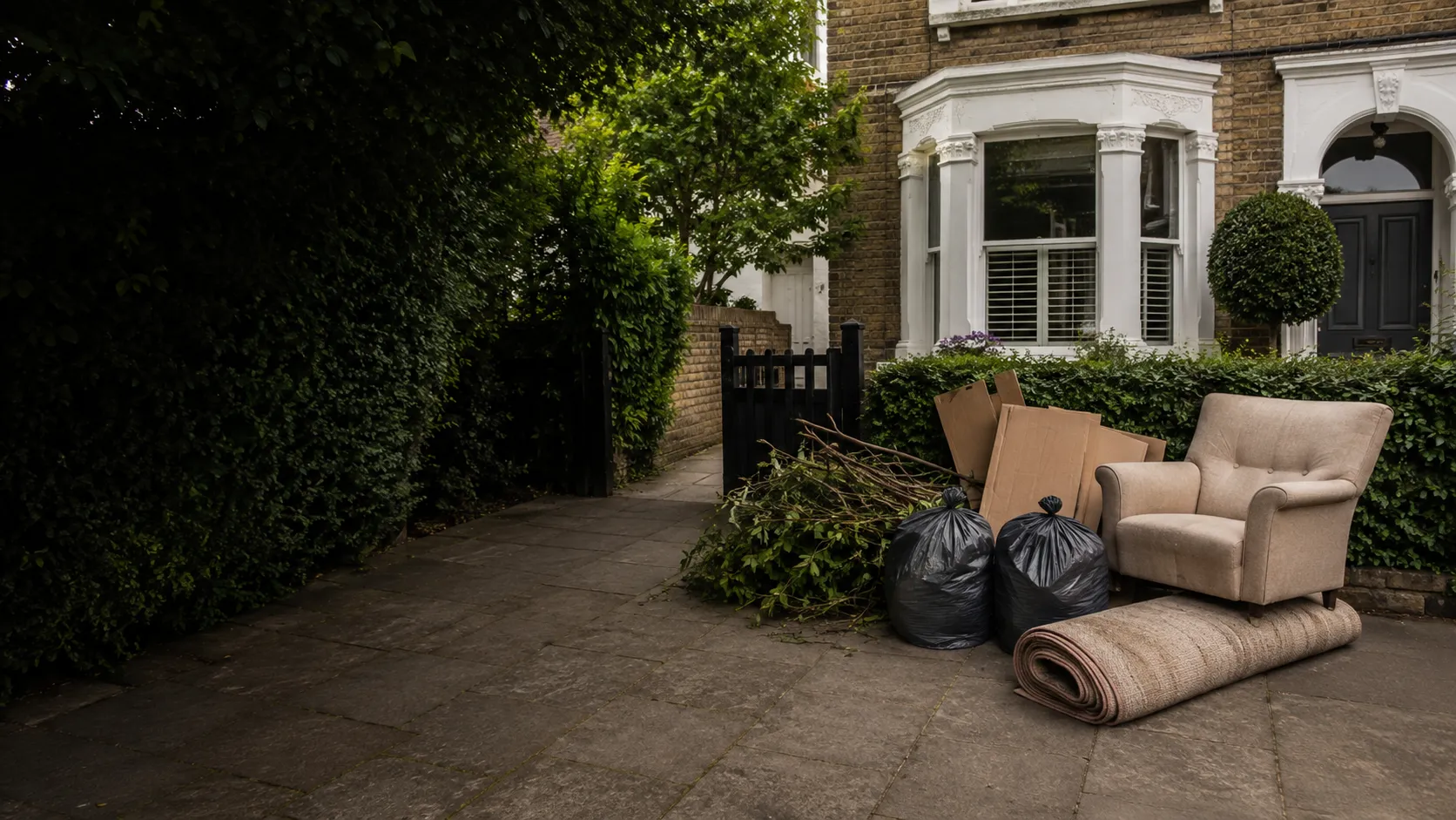 Household and garden items ready for collection outside a London home
